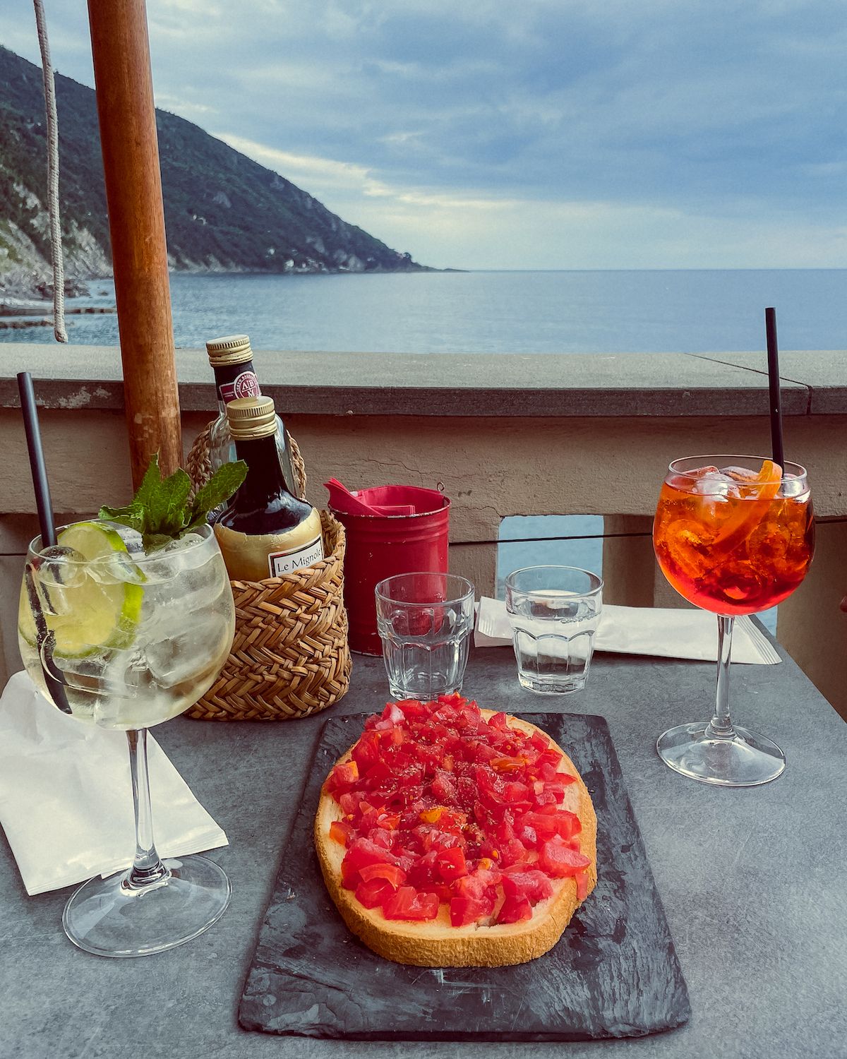 Bruschetta and spritzes at an outdoor table overlooking the sea in Camogli