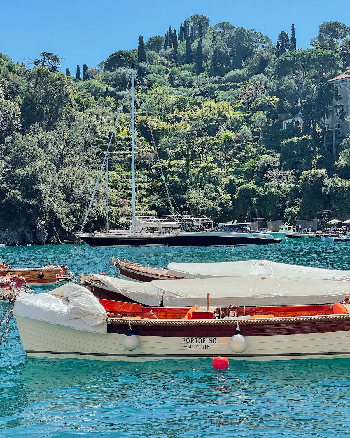 A chic white and brown boat in the harbour of Portofino