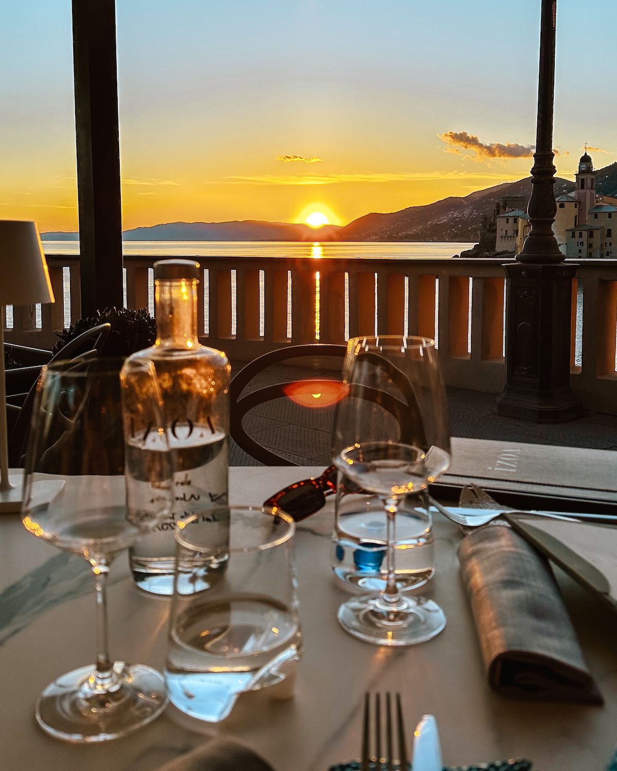The sunset hitting an outdoor dining table on the beachfront in Camogli