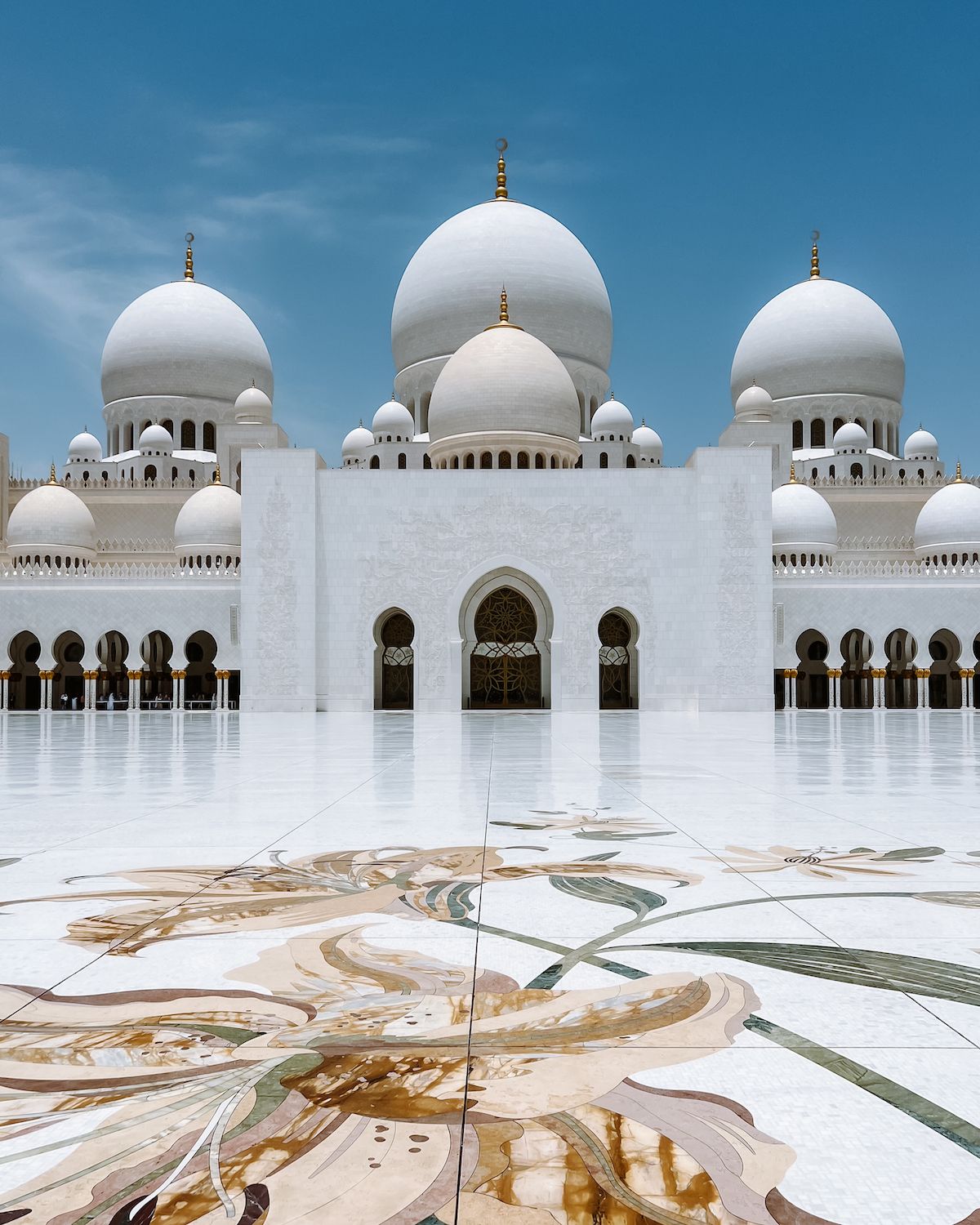 The stark white domes of the Sheikh Zayed Grand Mosque