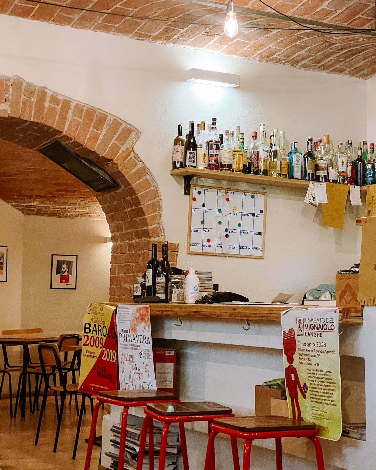 wine bar with brick arches and red stools
