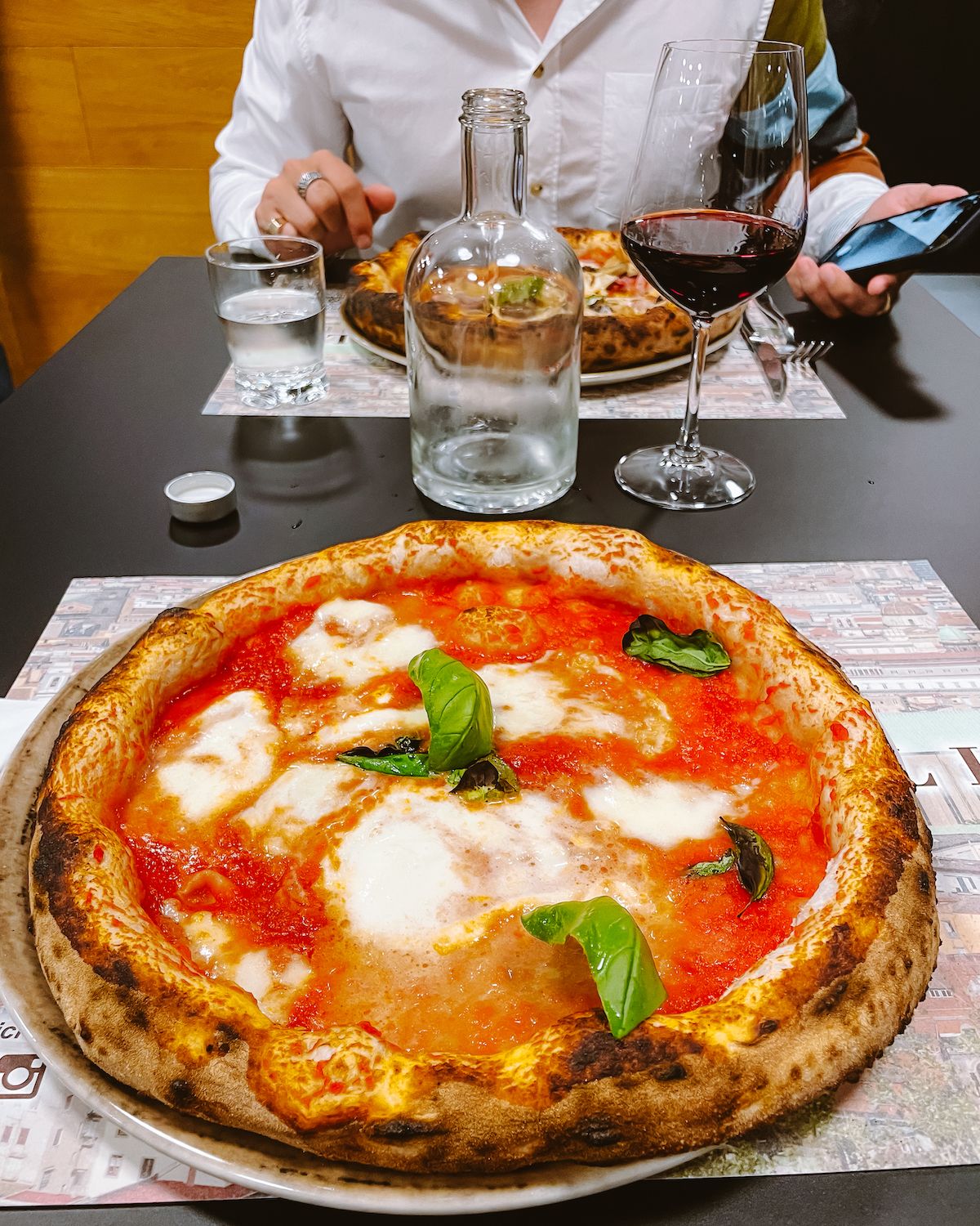 Margherita pizza with a glass of red dolcetto wine