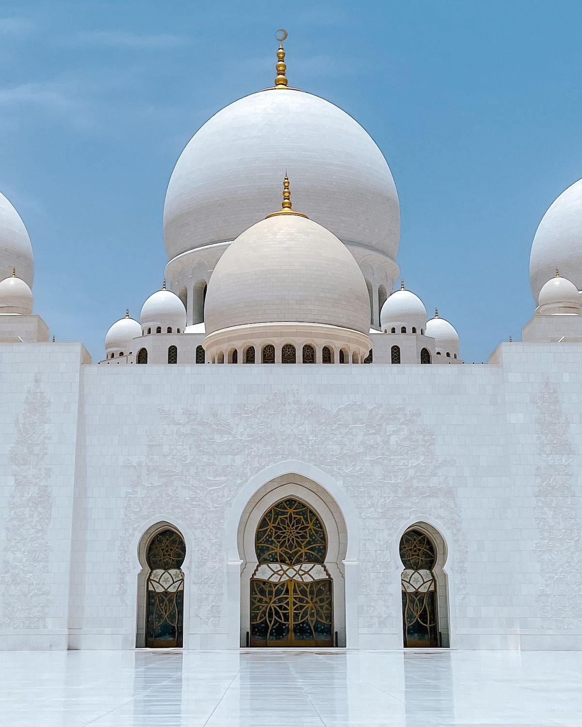Stark white domes of the Sheikh Zayed Grand Mosque
