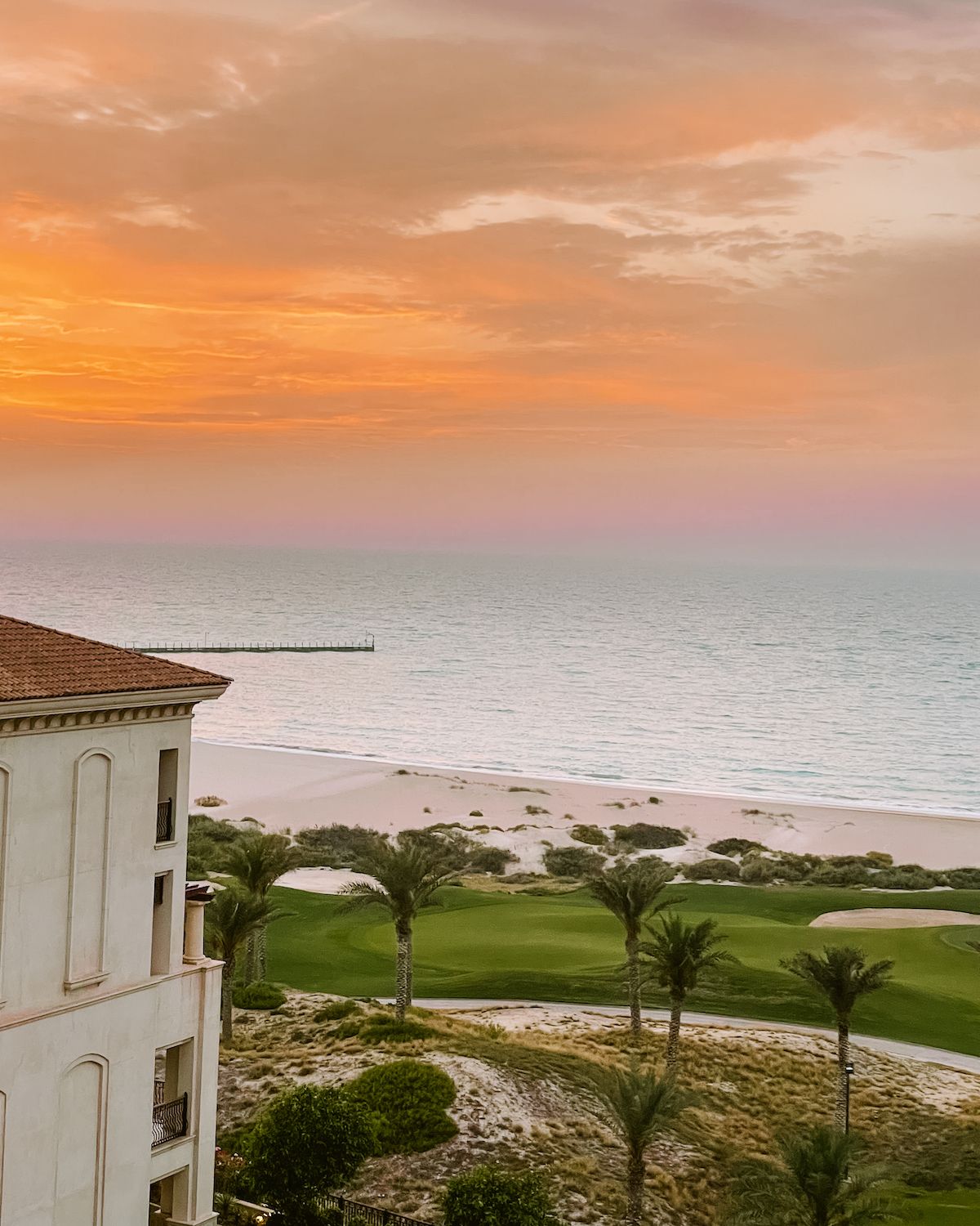 Orange and pink hues during sunset over the beach on Saadiyat Island