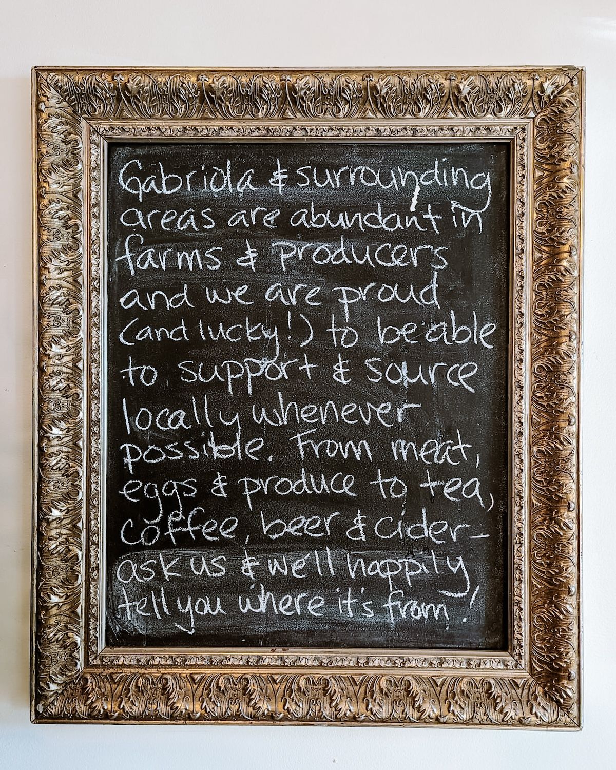 Chalk board in Ground up Cafe describing how they support and source locally