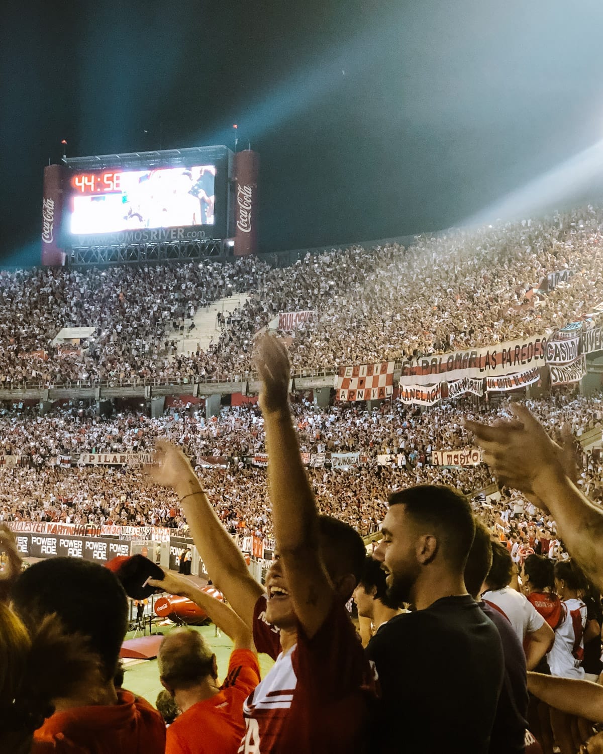 Fans cheer passionately during a River Plate vs. Racing Club match, a unique Buenos Aires football experience.
