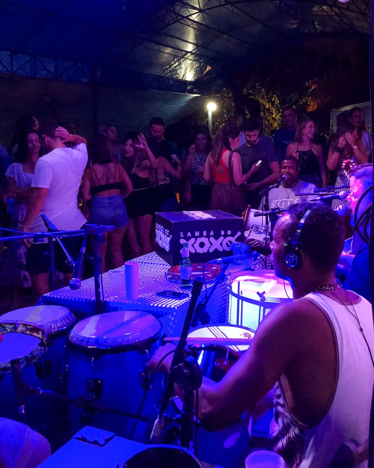 High-energy samba event at Mercado Das Pulgas, one of the best bars in Rio for samba, with musicians playing percussion and locals dancing.