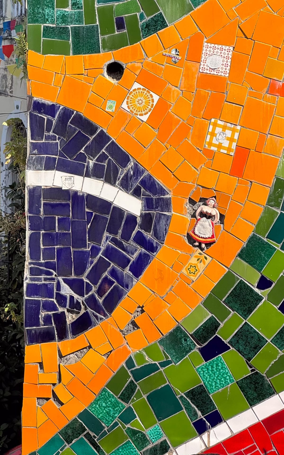 A colourful section of the Escadaria Selaron showing tiles in the colours of the Brazilian flag.