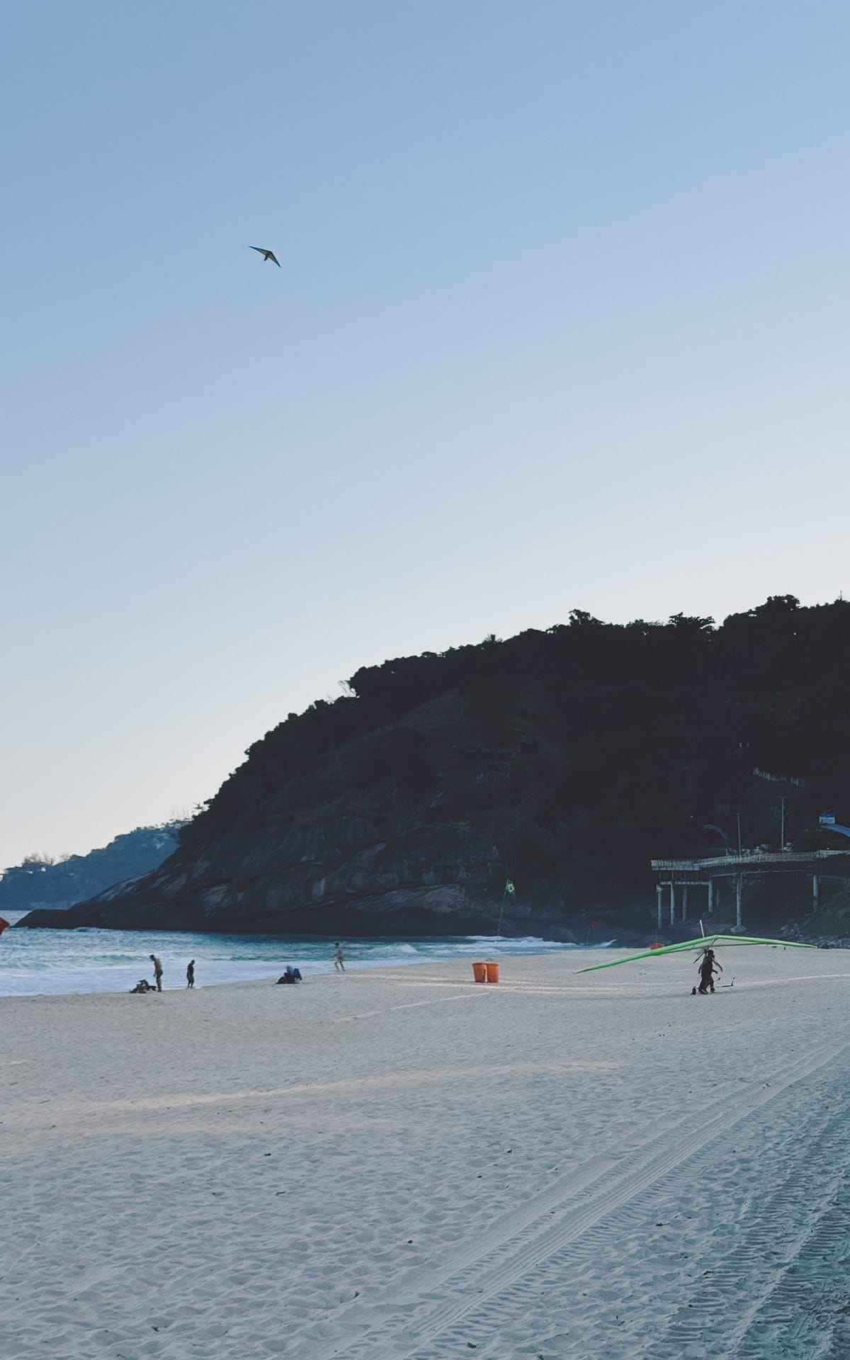 Quiet stretch of Pepino Beach in Rio with hang gliders, offering a peaceful escape from busy tourist areas.