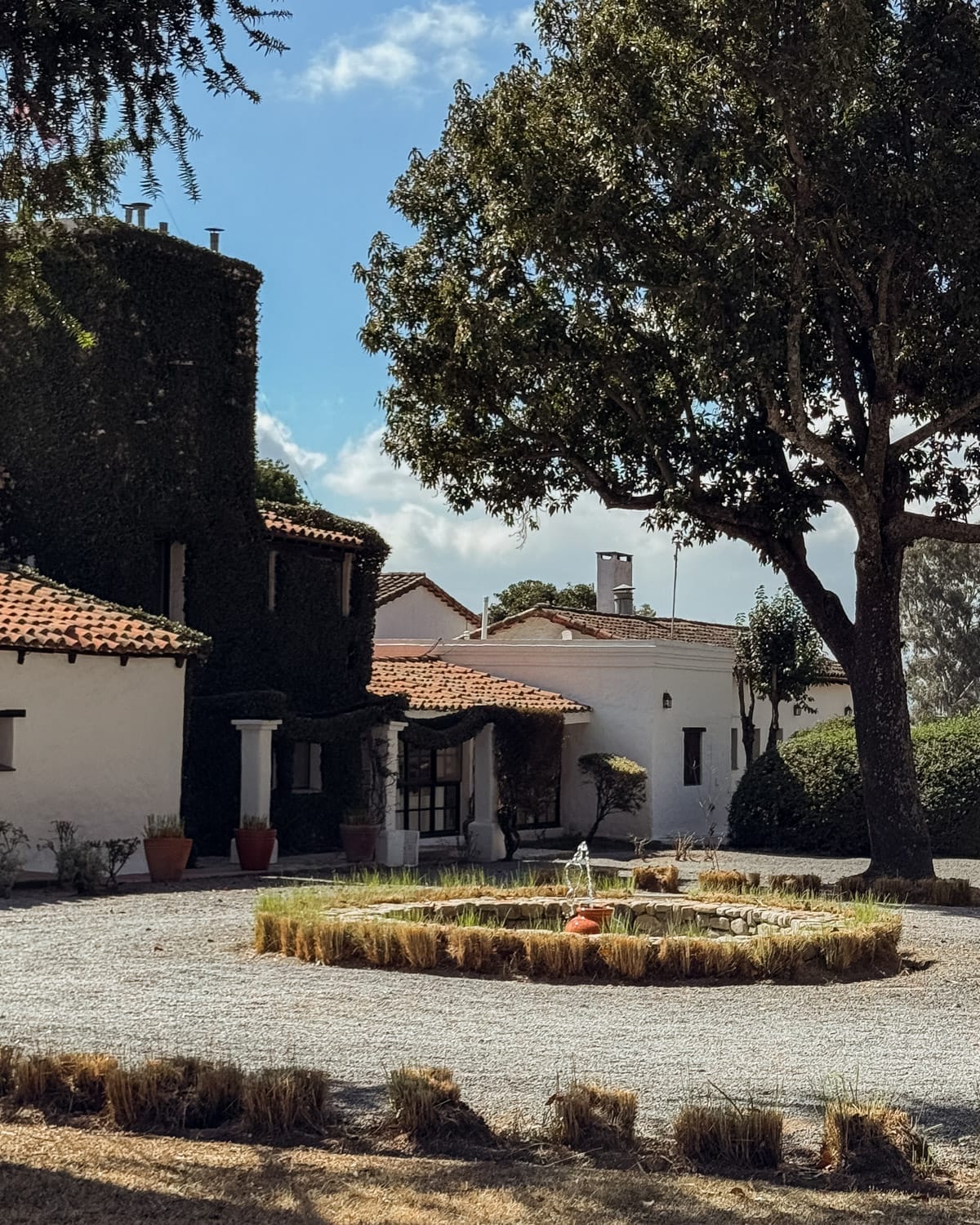 House of Jasmines Relais & Châteaux, a 19th-century estancia with ivy-covered walls, courtyard, and fountain.