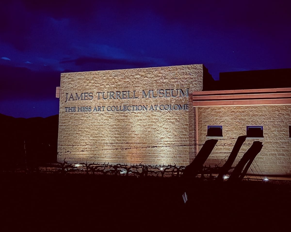 Exterior of the James Turrell Museum at Bodega Colomé, glowing at dusk in the remote desert of Salta.
