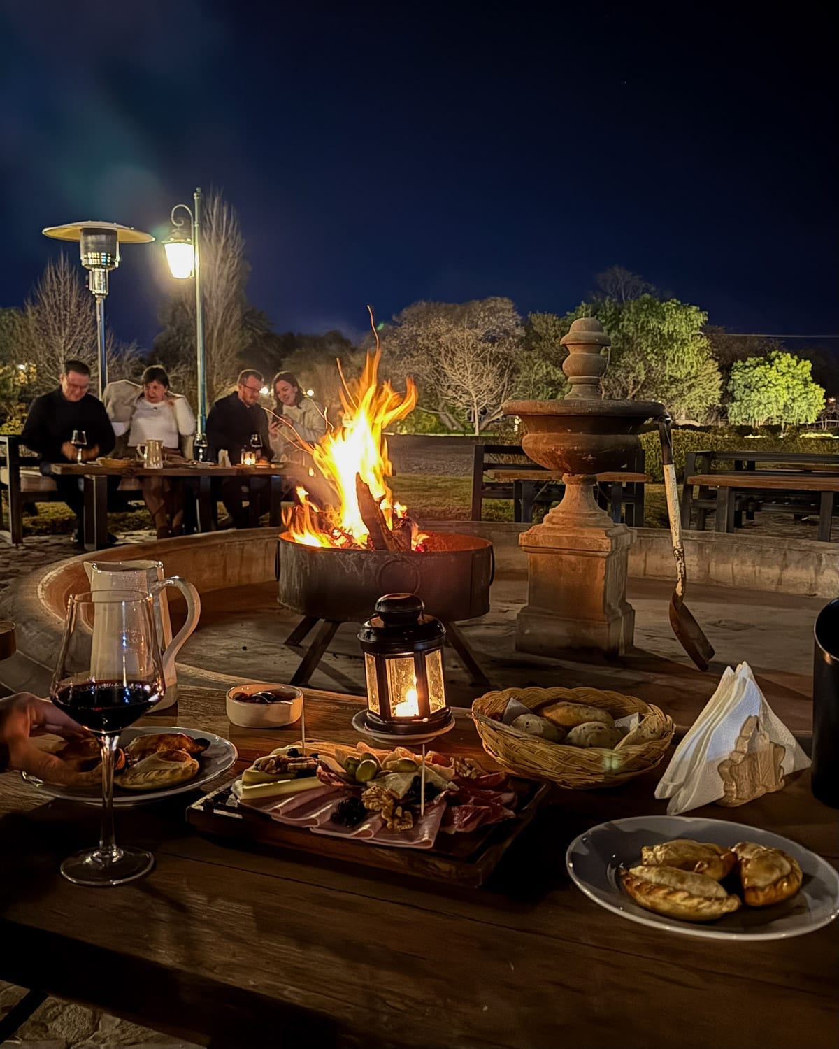 Charcuterie, empanadas, and wine around a bonfire during the “Night Under the Stars” experience at El Esteco.