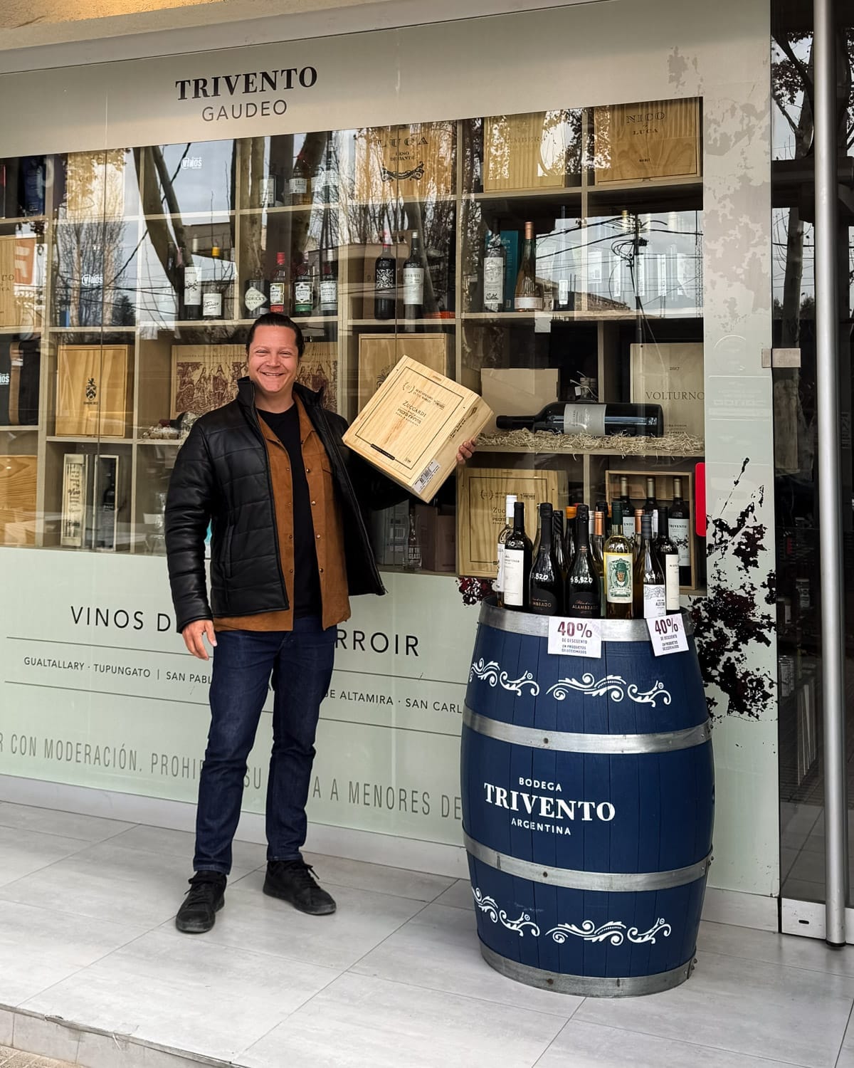 Ari holding a wine box outside a wine shop in Mendoza, Argentina.