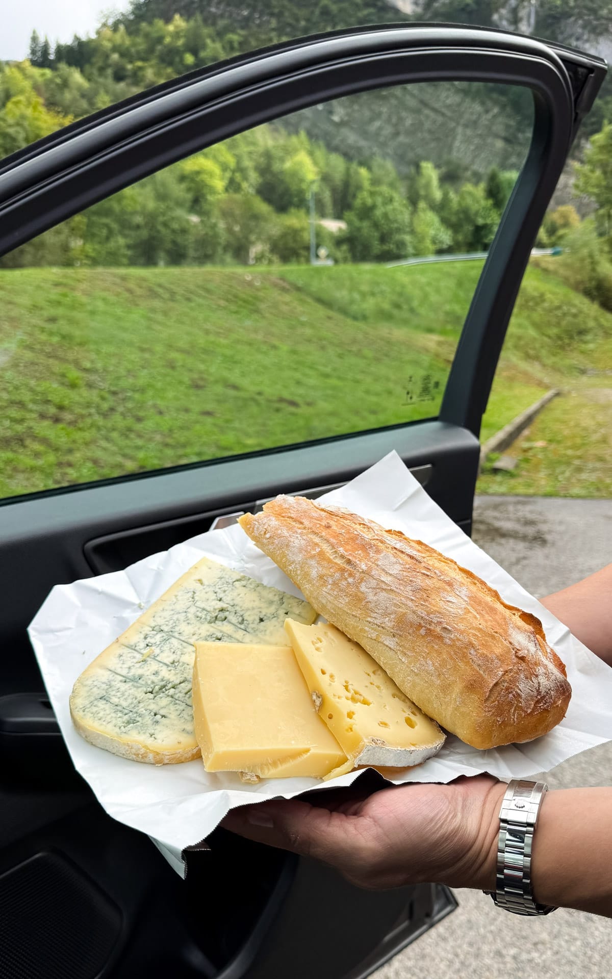 Roadside picnic of Comté and Bleu de Gex cheese with fresh baguette in the Jura.