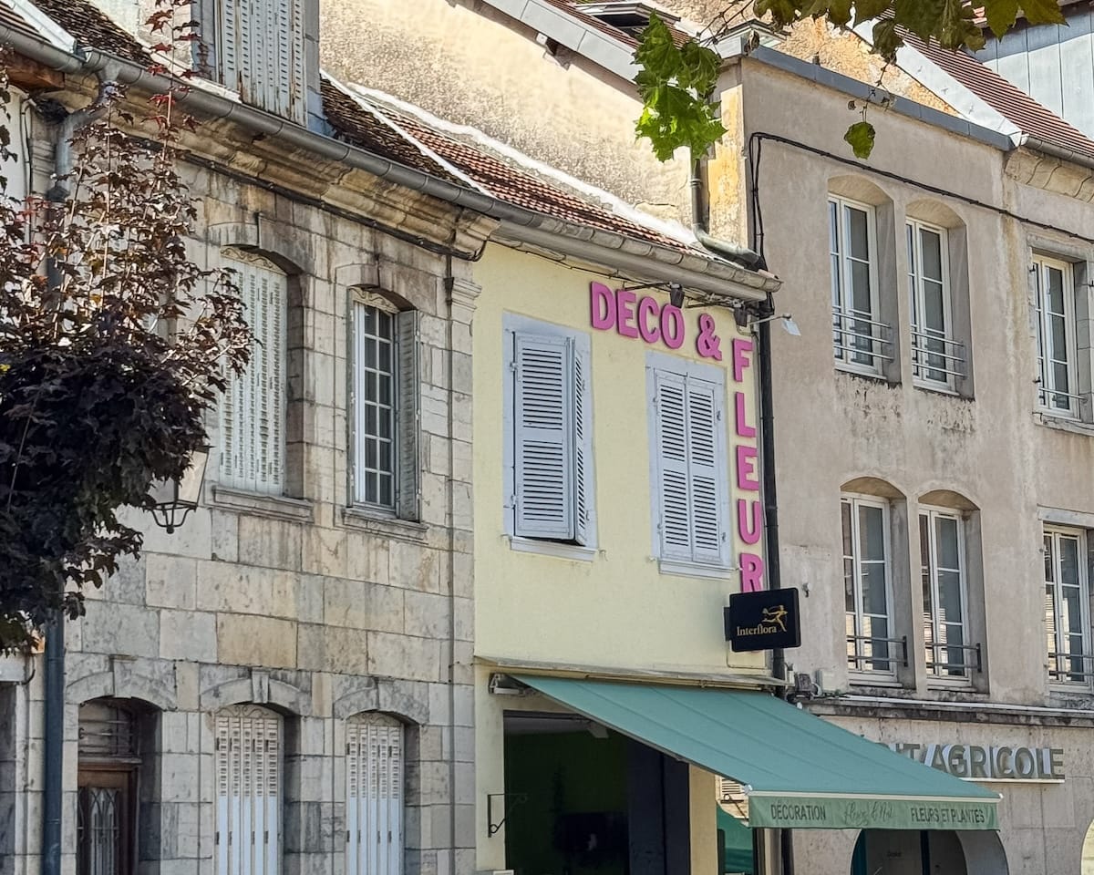 Colourful façades and small shops along a street in Poligny.