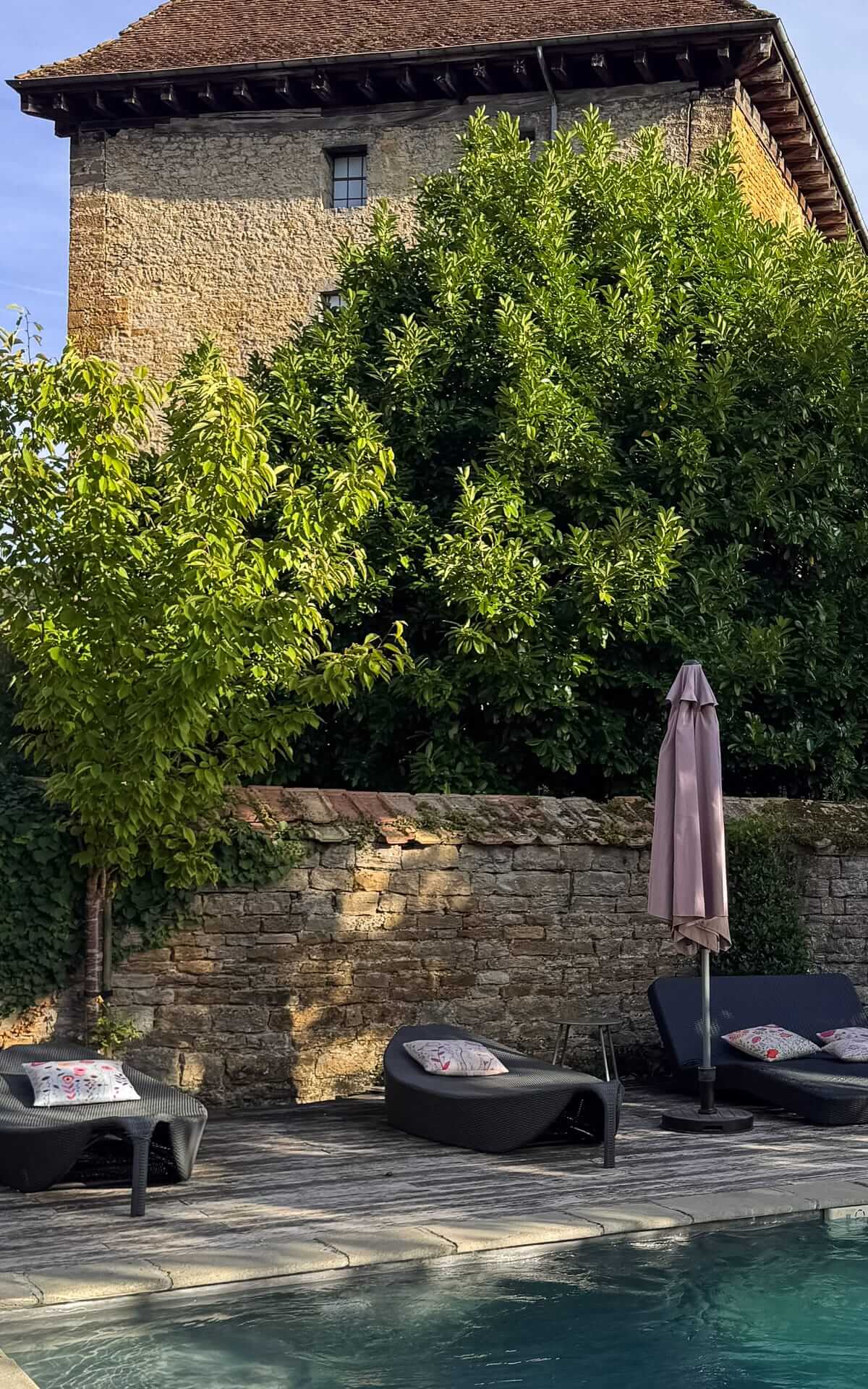 Outdoor pool and garden at La Closerie des Capucines, a restored 17th-century manor in Arbois.