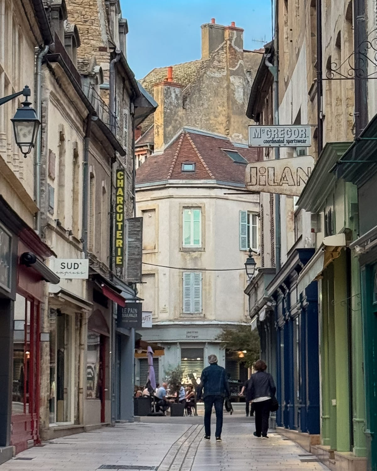 Pedestrian street in Beaune’s historic centre with shops and cafes.