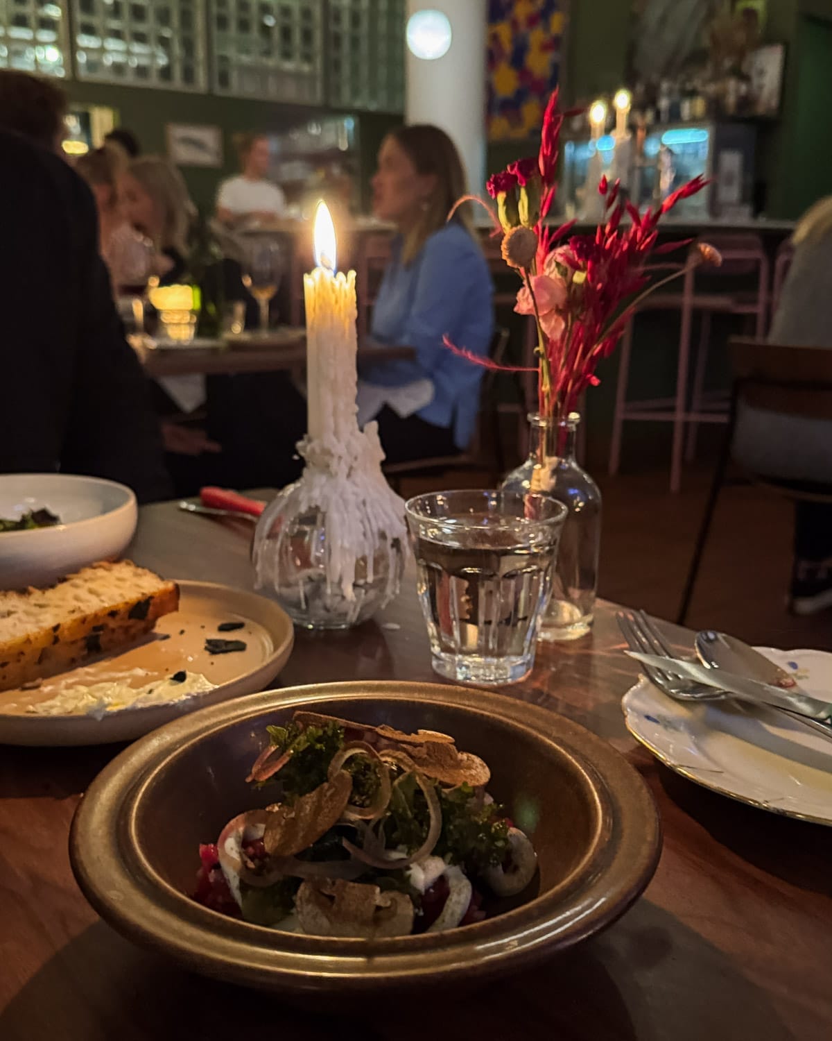 Candlelit dinner table with Nordic small plates at 305 Restaurant in Helsinki.