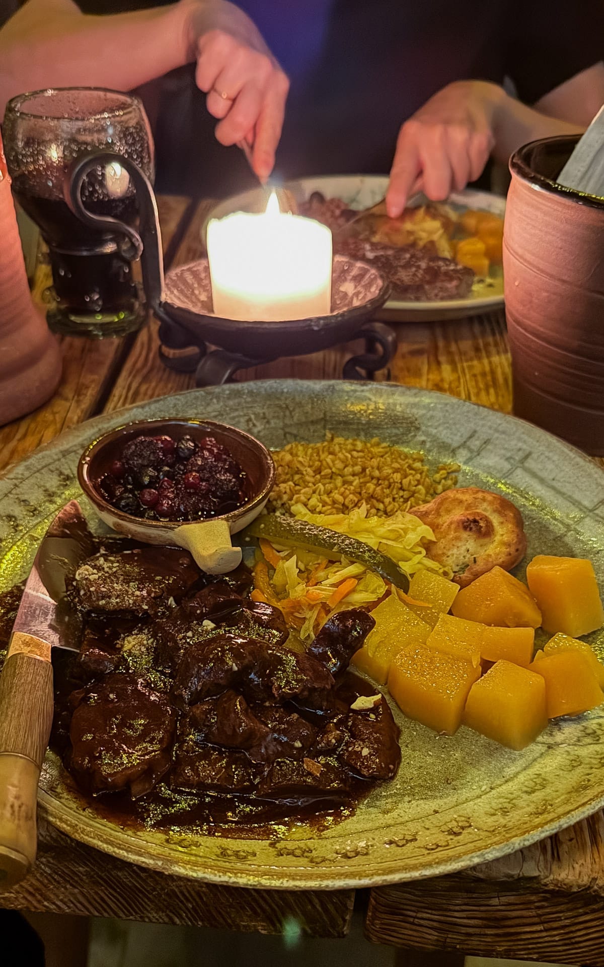 Medieval feast with stewed bear, barley, turnips and berries by candlelight at Olde Hansa.
