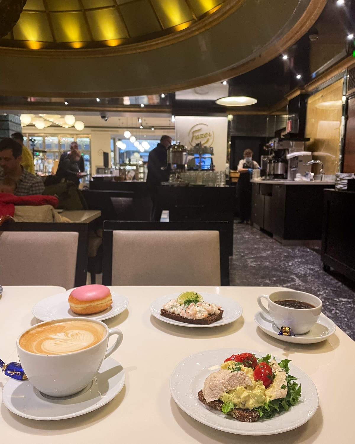 Traditional Finnish café setting at Fazer with coffee with open-faced shrimp and chicken sandwiches.
