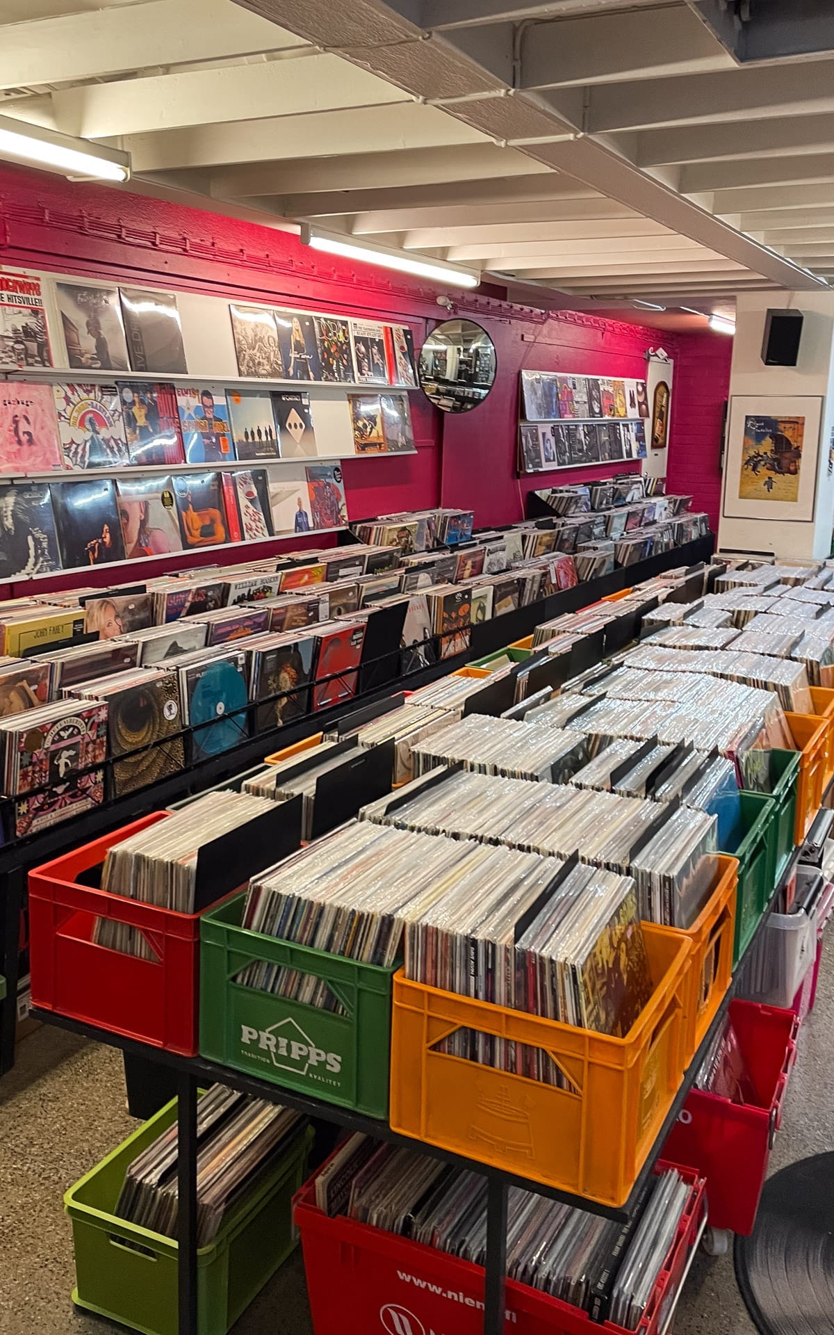 Interior of a Helsinki record shop with rows of vinyl records displayed in colourful crates.