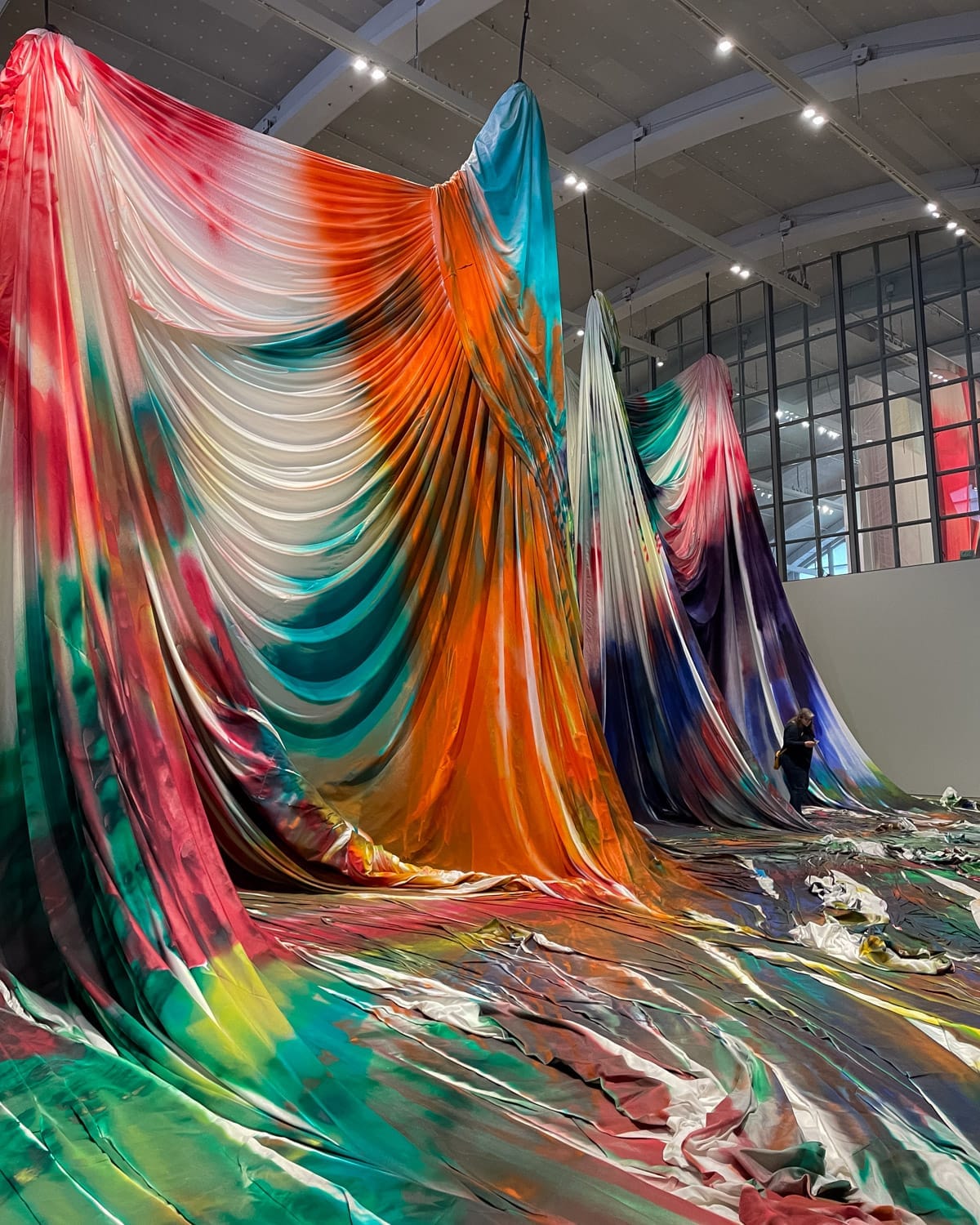 Large-scale contemporary textile installation at Helsinki Art Museum, featuring dramatic draped fabric in vibrant colours.