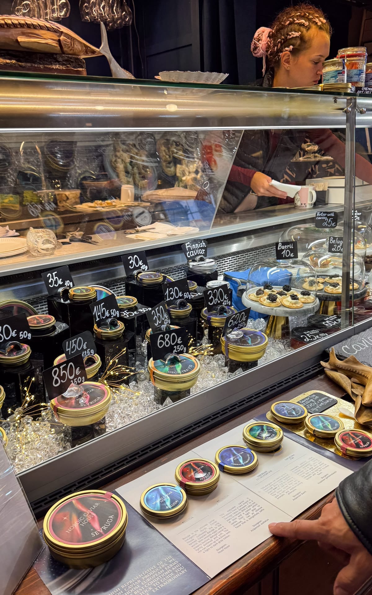 Caviar tins and blinis displayed at a Nordic caviar counter inside Helsinki’s Old Market Hall.