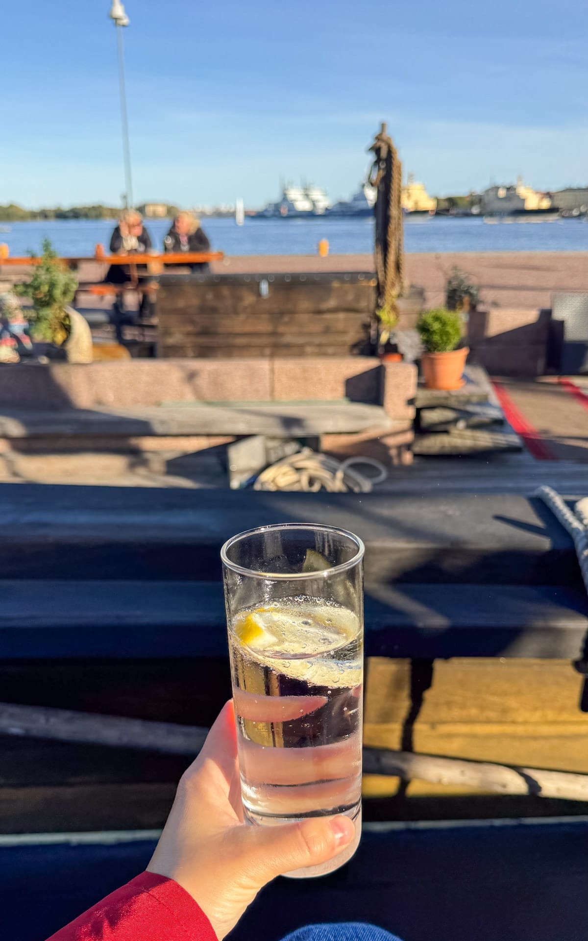 Cocktail in hand on the deck of Bar Jan Mayan, a historic harbour ship.