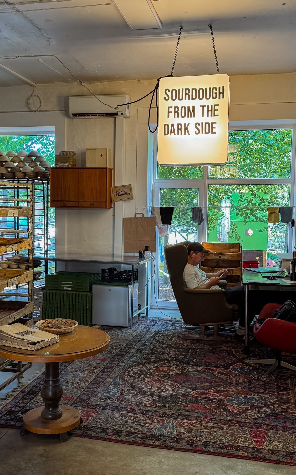 Cozy bakery interior and studio with hanging sign reading “Sourdough from the Dark Side” in Telliskivi Creative City.