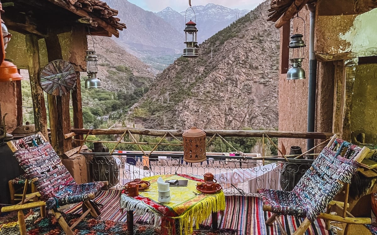 Cozy mountainside terrace of a Berber Lodge in the Atlas Mountains, a cultural travel experience.
