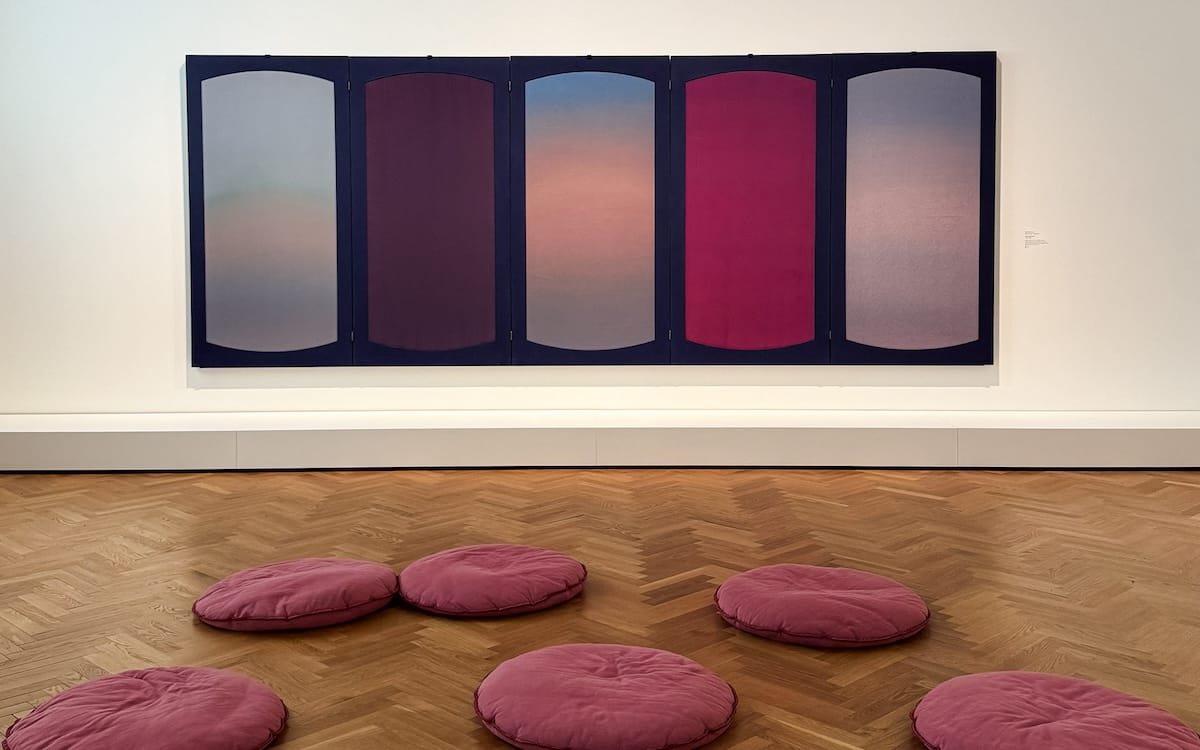 Large gradient panel artwork in a gallery space with round pink floor cushions at KMSKA, a must-visit for your one day in Antwerp.
