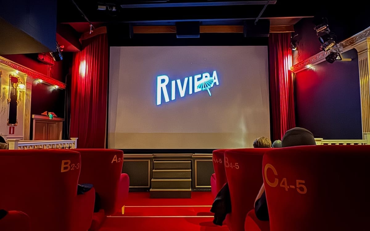 Movie screen and comfy red lounge seats at Riviera Cinema, a fun thing to do in Helsinki at night.
