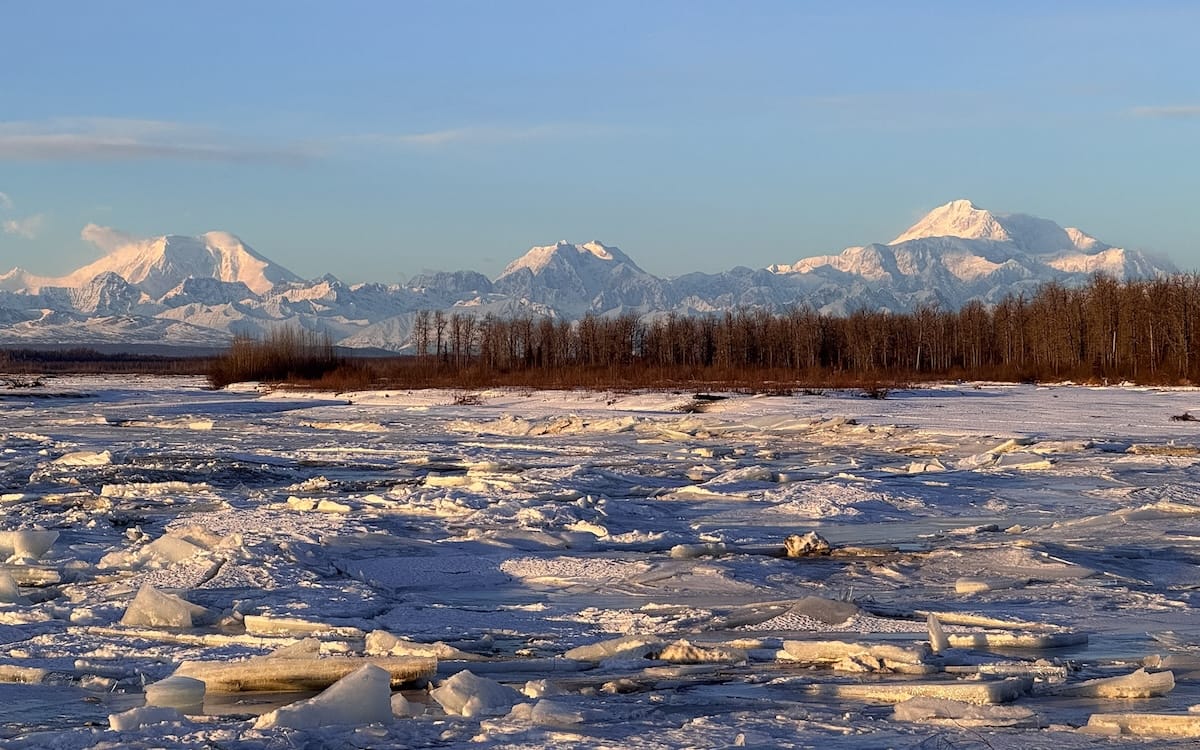 Frozen river and snow-covered Alaska Range from the Denali Lookout in Talkeetna, a fun thing to do in Winter.